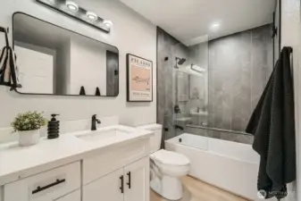 Spa-inspired bath with Tulum-style tile and frameless glass shower.