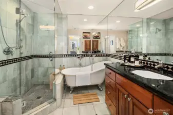 Spa-inspired bathroom features a clawfoot soaking tub and walk-in shower.