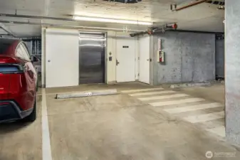 Secure garage parking space located beside elevator.
