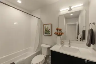 Photos of model home with similar finishes & floor plan. This thoughtfully designed bathroom features sleek finishes, a full tub, and ample counter space—perfect for your morning routine or an evening soak.