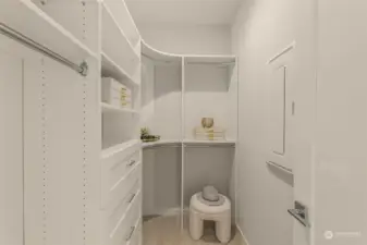 Photos of model home with similar finishes & floor plan. Designed with organization in mind, this spacious walk-in closet offers custom shelving, ample storage, and a dedicated space to keep everything neatly tucked away.
