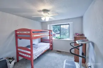 Bedroom three has newer carpet and views of mature landscping.