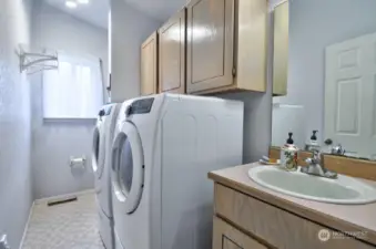 Laundry room with sink and half bath.