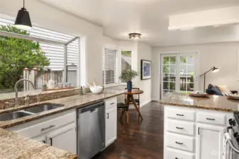 Large window above the sink looking out onto the backyard.