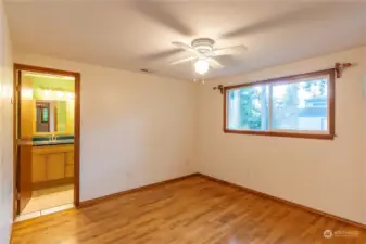 Primary bedroom with primary bathroom off this bedroom. Bedroom is at the back of the home. Hardwood floors with cedar floor in the large closet.