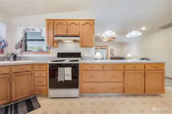 Kitchen opens to vaulted family room behind