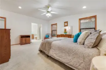 Owner’s suite vaulted ceiling with ceiling fan with opening to suite