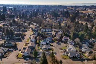 South facing Aerial shows hills in distance: Portland’s West Hills and Forest Park Hiking Trail areas