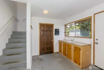 The hobby area in the garage with stairs up to the bonus room.