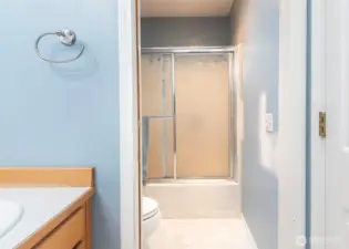 Hall bathroom with dividing door for privacy.