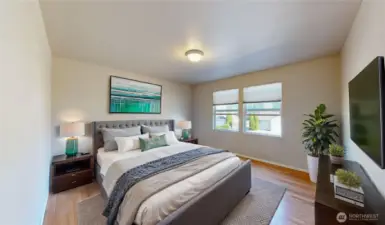 Primary suite, filled with natural light and warm hardwood flooring, offers generous space for a king-sized bed. Photo is virtually staged.