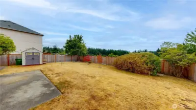 Fully fenced backyard offering privacy and peaceful views with no neighbors behind. Spacious yard features a storage shed, mature landscaping, and room to garden, play, or entertain. Concrete patio provides the perfect spot for outdoor dining or relaxing while enjoying the natural surroundings.