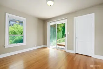 This main floor bedroom enjoys direct access to the backyard deck. as well as oak hardwood flooring.