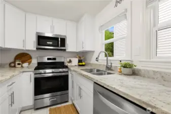 Modern kitchen with stainless appliances, gas cooktop, and quartz countertops