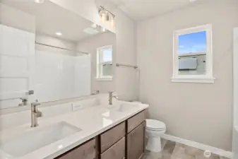 Main bathroom second level with dual sinks and quartz countertop. Home under construction, photo for illustration only.