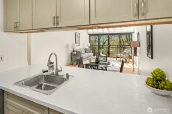 The kitchen seamlessly flows into the living space, offering a functional and cohesive layout perfect for entertaining.