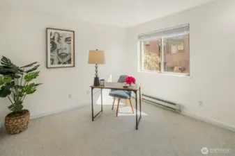 A versatile second bedroom, freshly painted and ready to serve as an expansive office or inviting guest space.