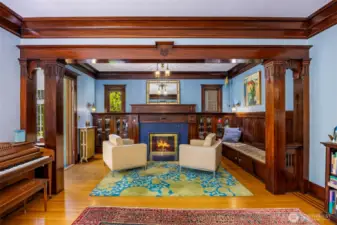 Cozy retreat framed by wood details and a fireplace.