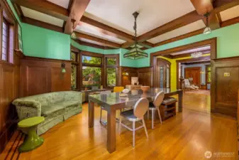 Sunlit dining room with original oak detailing and elegant doors leading to  the foyer and front entry.