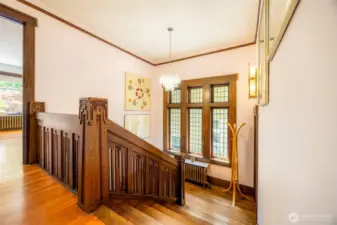 Graceful wood staircase to the upper level.