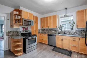 Calling all chefs! This kitchen is amazing with its flooring, ample counter space and cabinetry.