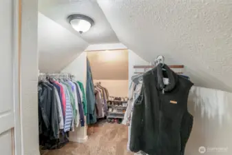 The large walk in closet is full of storage and ample space for clothes and shoes.