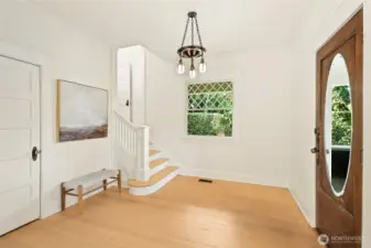 Beautiful entry | pass through staircase & original pocket doors to the living room.