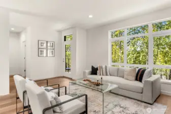Walls of windows flooding in natural light from your greenbelt view