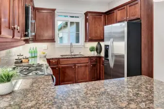 Stainless appliances, gas range, side-by-side refrigerator/freezer with in-door ice and water.