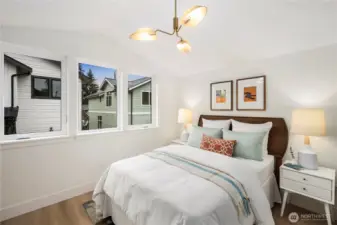 Guest room with vaulted ceiling and ample natural light