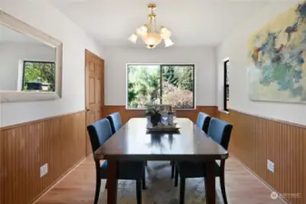 The formal dining room is right off the  kitchen for easy access when entertaining.  This is a great space for friends and family to  gather! To the left, you'll find a pantry for all  your hosting dinnerware, serveware and  linens.