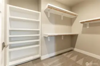 Primary closet with all built in shelving.