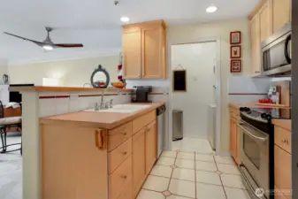 Kitchen is open to the dining and living area so you are always part of the action when you entertain. Notice the stacked washer/dryer on the right. There is shelving for extra pantry to the left.