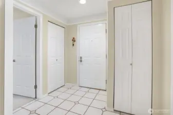 Entry area. DOORS: Left door is to the second bedroom, second door is coat closet, middle door is the entrance, and door to the right is a linen closet.
