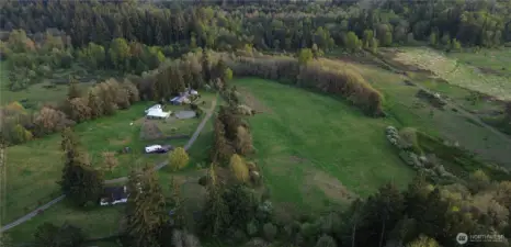 Aerial view of the 39 acres,main home, upper, middle and lower pastures as well as the orchard, old 1920 farmhouse, RV pad, barns, shed and Conex for storage.
