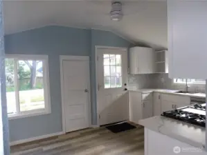 Entering kitchen from living room. The door you see here goes outside to the deck and back yard.