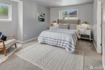 The primary suite features a cozy reading nook, wall-to-wall mirrored double vanity and a walk-in closet.