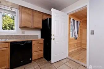 That's a neat little wood-wrapped room off of the kitchen with French doors leading out to a nice deck for relaxing.