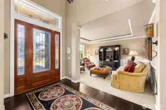 Enhanced with rich crown molding and  stunning coffered ceilings this formal living  room has an abundance of natural light.