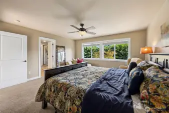 Primary suite featuring a large picture window that fills the room with natural light, plus an attached ensuite bathroom for ultimate comfort and privacy.