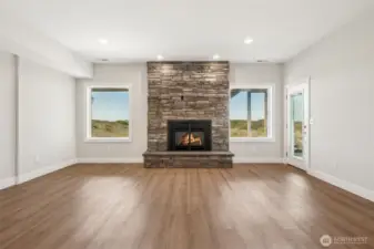 Entry level living room with fireplace and patio access.