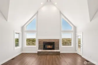 2-story vaulted ceiling with custom propane fireplace and under-mantle lighting. Deck access from the living room amd those ocean views.