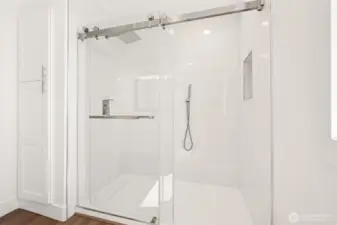 Custom tile shower and added storage in the spacious guest bath.