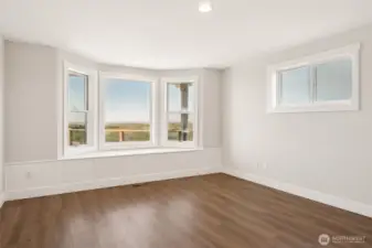 The primary suite is located on the main living level (2nd floor). Window seat with storage is the perfect spot to enjoy the ocean views.
