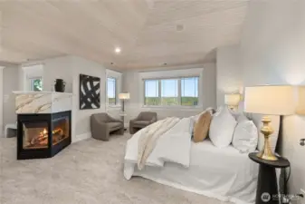 The primary suite has vaulted ceilings, a fireplace, sitting area and covered balcony.
