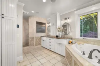 The expansive primary bathroom with dual sinks, a jetted tub, heated floors and more.