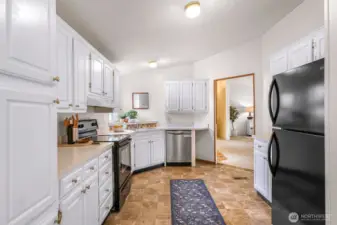 This kitchen is ready and waiting your special touches!  The living room is seen to through the doorway.  All appliances stay. Yes, there's a dishwasher, stove, refrigerator, just bring your microwave if you use one.