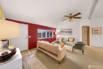 The door you see on your left, is the front porch to your entry area.  High ceilings and fan/light fixture.  The primary bedroom doorway is seen to your right.