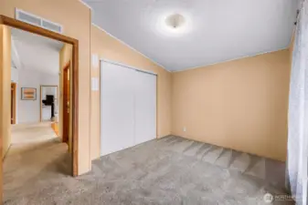 3rd bedroom also has a large closet.  The water heater is also located in the closet, yet not IN the closet space.  You see the hallway to the 2nd bathroom, looking towards the living room and kitchen from here.