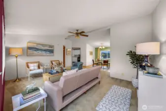 Back in the living room, standing at the front porch entry, an entire view over the middle space of this home.